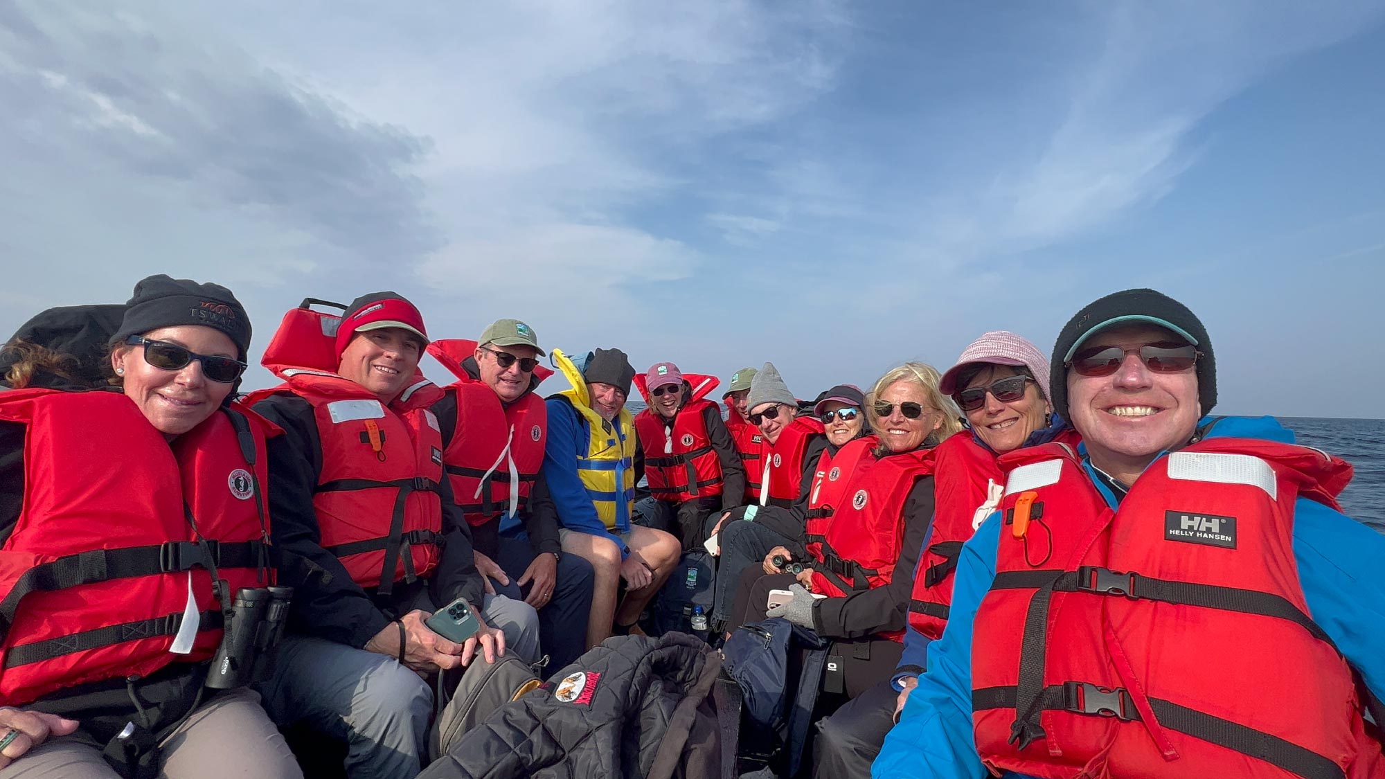 Group of adventurers aboard a boat on a beluga whale encounter tour.
