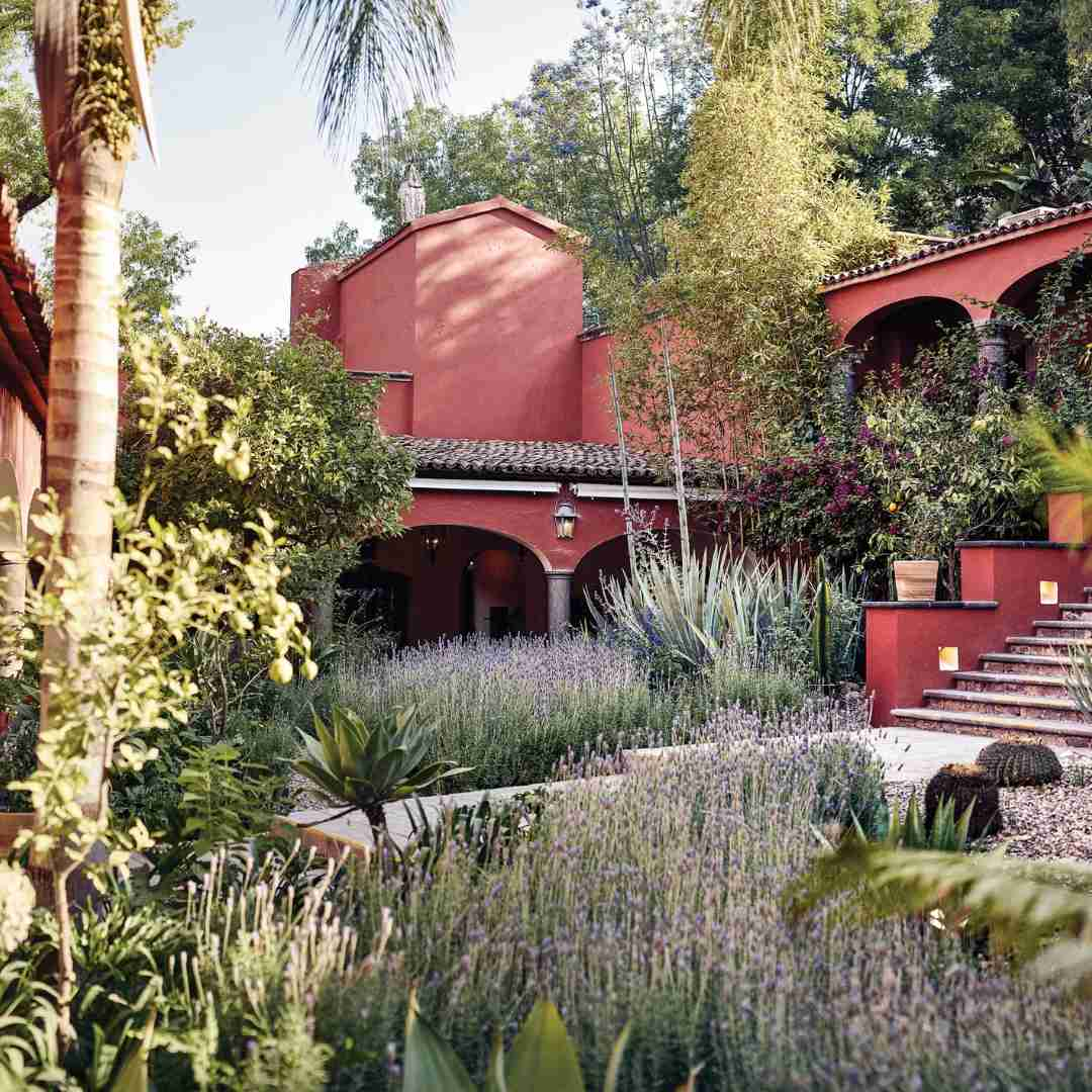 A captivating photograph showcasing Belmond Casa de Sierra Nevada in San Miguel de Allende, Mexico. The hotel's colonial facade adorned with colorful bougainvillea against warm terracotta walls reflects the city's cultural richness.