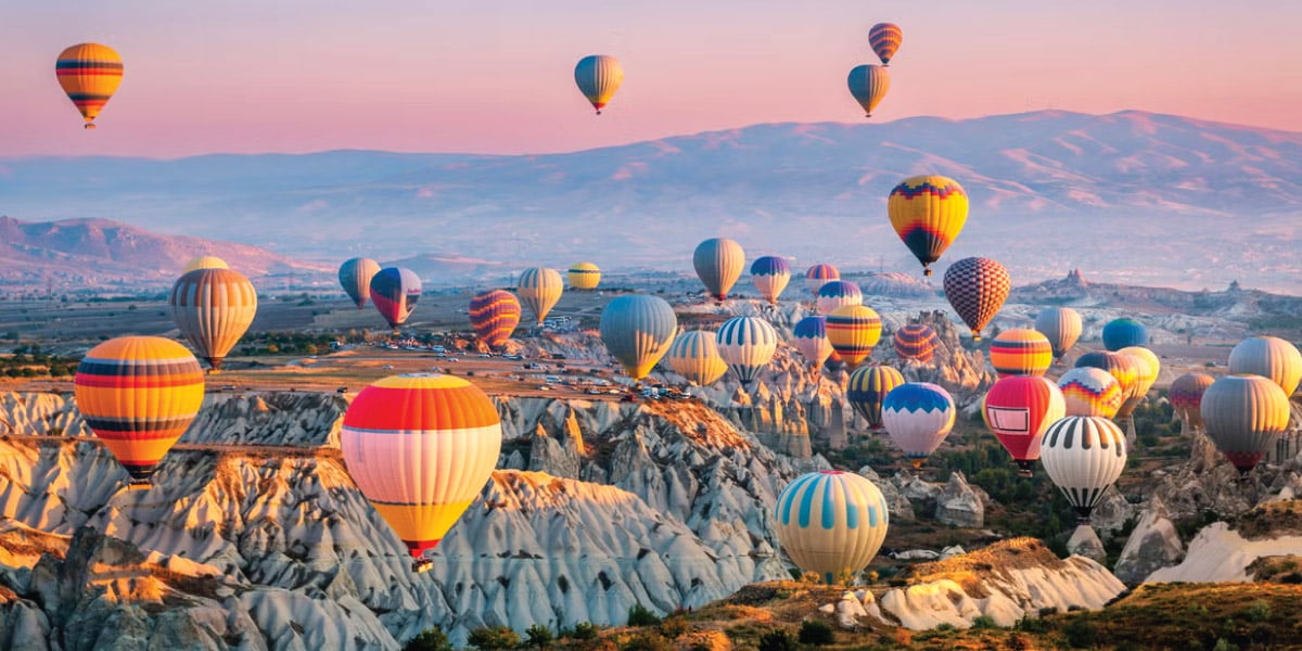 Hot air balloons floating over Cappadocia, Turkey, inspire self-flying pilots with their own aircraft to explore the breathtaking landscapes and cultural wonders of Eurasia, offering a unique perspective on a journey through ancient history and natural beauty.