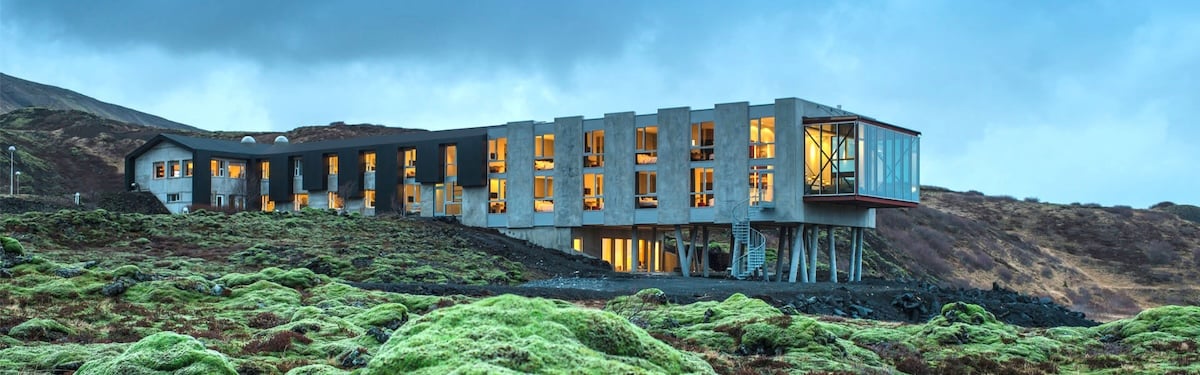 A stunning view of the Ion Hotel nestled in Iceland's breathtaking natural surroundings, offering a luxurious retreat for travelers on a self-flying journey through the country