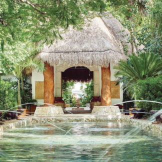 A welcoming view of the entrance to the Belmond Maroma in Cancun, Mexico, showcasing its lush surroundings and inviting atmosphere. Tailored for self-flying pilots
