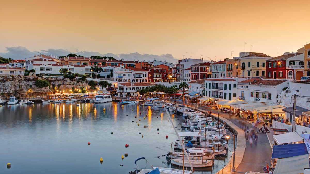 A captivating aerial view of Menorca, Spain, showcasing its pristine beaches, turquoise waters, and charming coastal villages. Tailored for self-flying pilots planning a European adventure