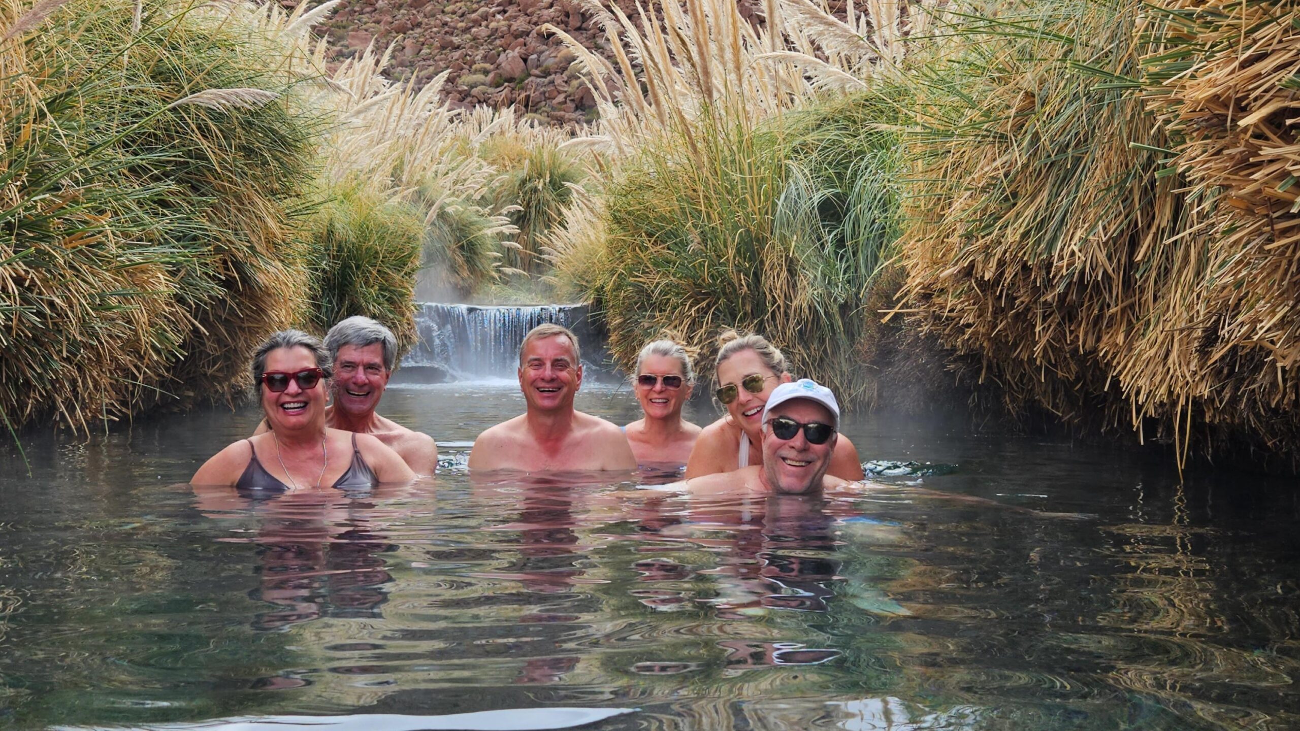 A group of travelers enjoying a bath at Puritama Hot Springs in San Pedro de Atacama, Chile.