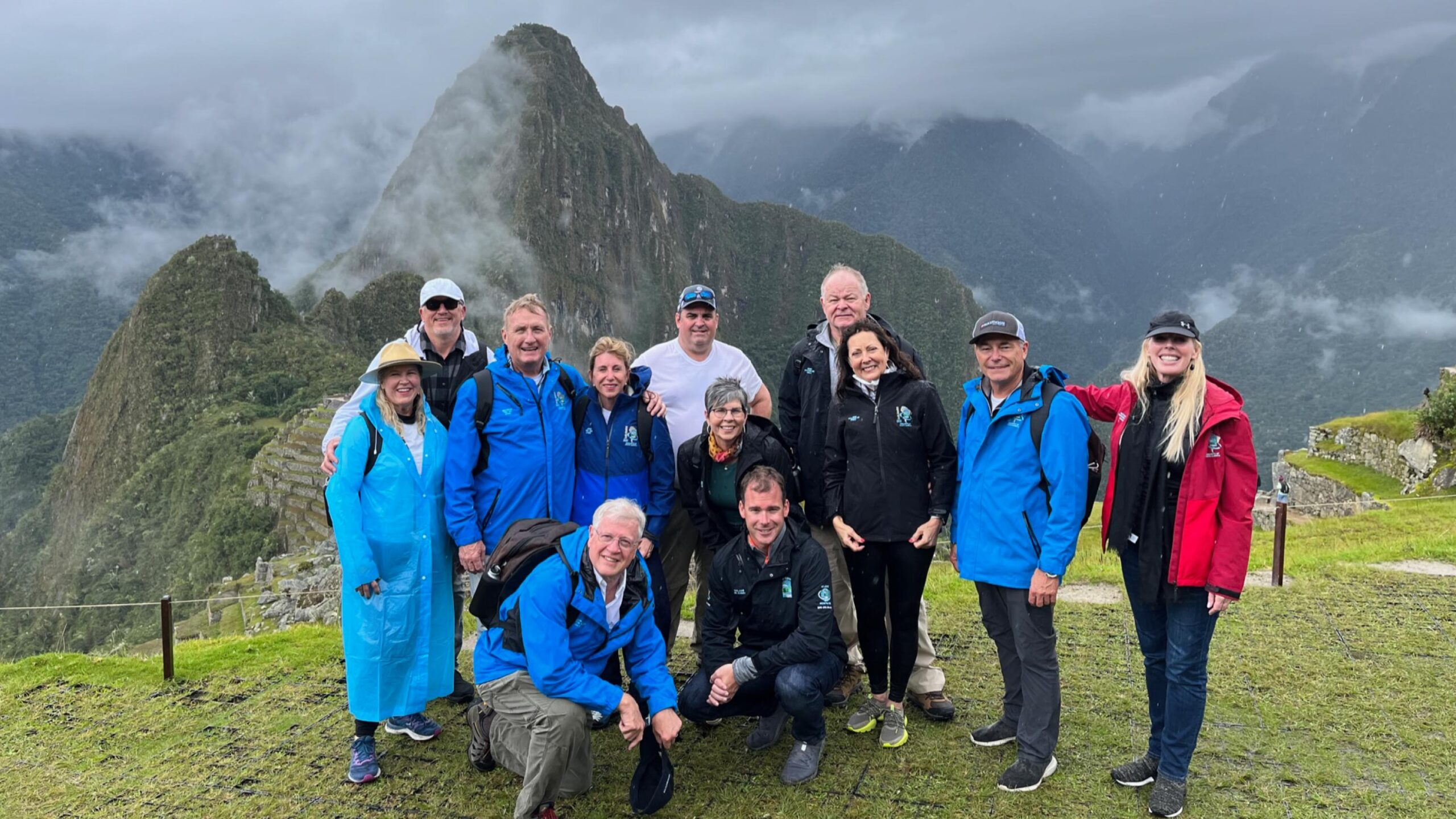 Adventurers enjoying the amazing vista of Machu Picchu, Peru