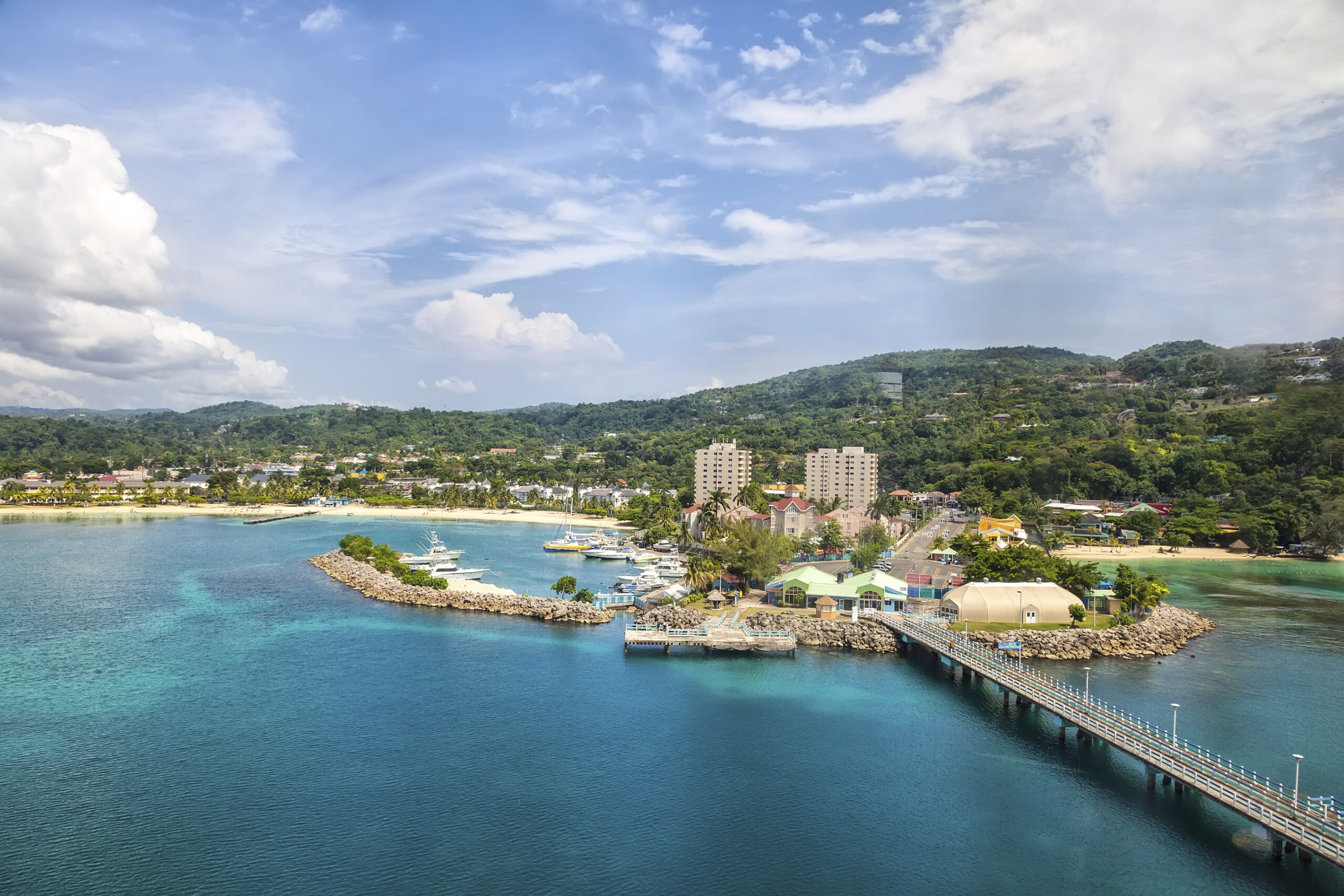 An aerial vista of Montego Bay, Jamaica, revealing its turquoise waters and lush greenery. Ideal for self-flying pilots planning a journey to South America.