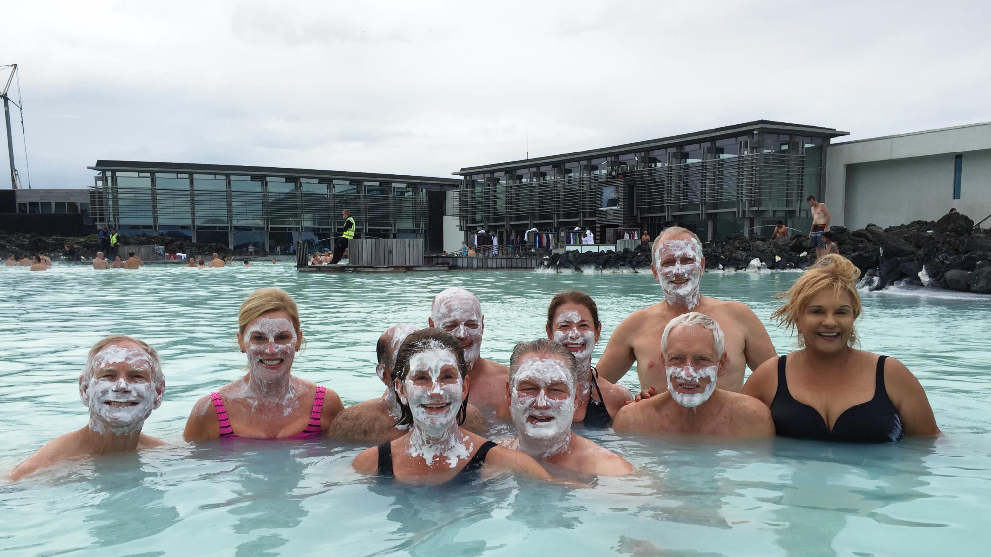 Friends laugh and unwind in the soothing turquoise waters of Iceland's iconic Blue Lagoon