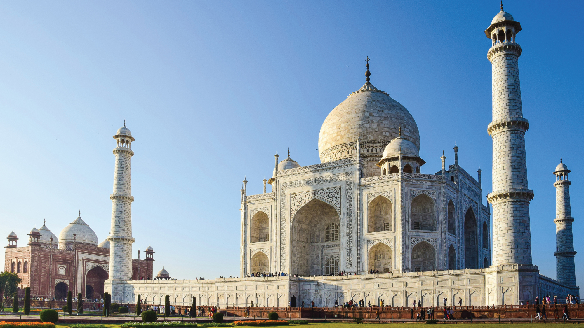 The iconic Taj Mahal surrounded by lush gardens.