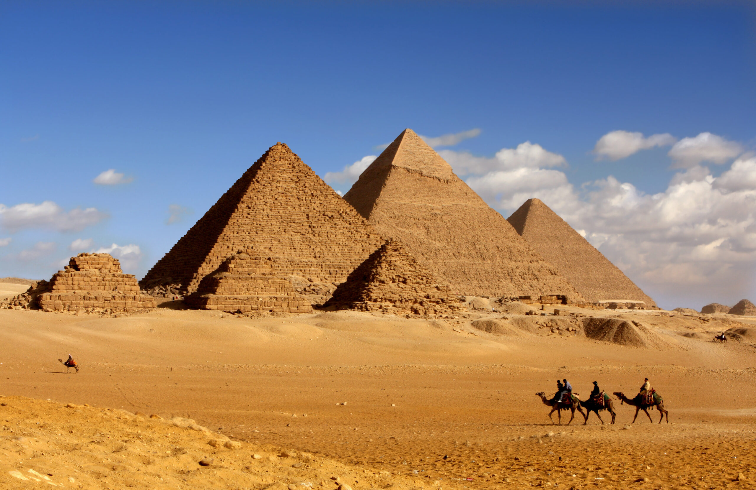 pyramids giza cairo in egypt with camel caravane panoramic scene