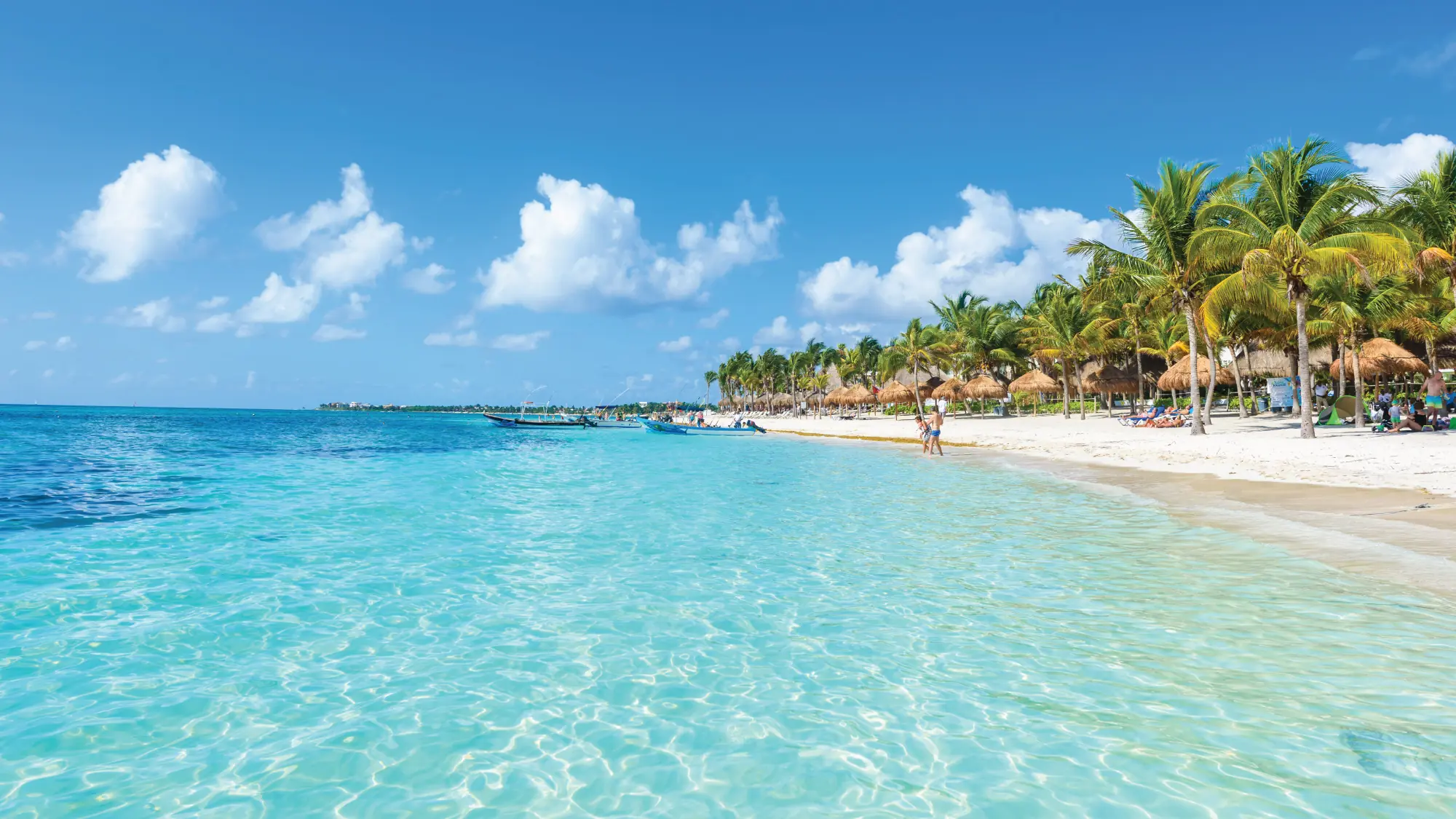 A breathtaking view of a pristine turquoise beach in Cancun, Mexico, with white sandy shores and clear blue waters. Tailored for self-flying pilots